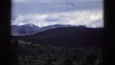 Yellowstone Wyoming USA (1958): A Scene Of Large Mountains Trees The Sky And