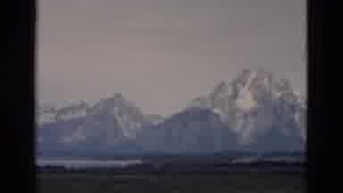 Yellowstone Wyoming USA (1958): View Of Snow Covered Mountains And Green Fields On