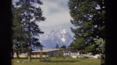 Yellowstone Wyoming USA (1958): View Of Snow Covered Mountains And Green Trees On