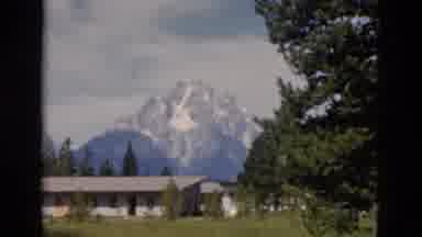 Yellowstone Wyoming USA (1958): House Or Community Sitting On Land With A Mountain