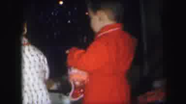 Lynbrook New York (1971): Boy Wearing Red Robe Removes Candy Stockings From