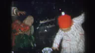 LYNBROOK NEW YORK-1971: Toddler Climbs Over Gifts And Wrapping Paper On The Floor