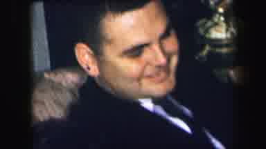 Lynbrook New York (1971): One Man Sitting In A Chair Laughing Out Loud In A Suit