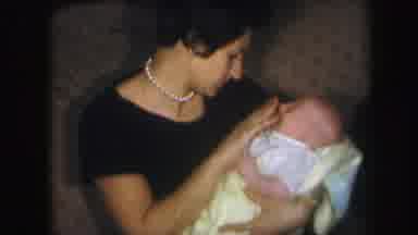 Lynbrook New York (1971): Woman With Newborn Baby Sitting On The Sofa At Home