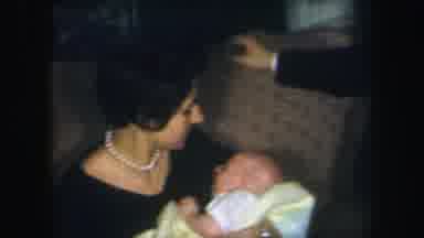Lynbrook New York (1971): A Woman Holding A Baby While Sitting On A Couch And A
