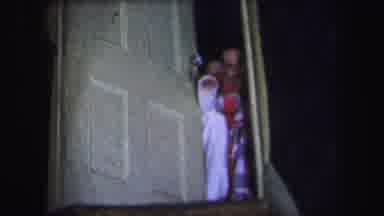 Lynbrook New York (1971): Two Young Children Waving From A Half Closed Door At The