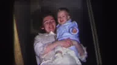 Lynbrook New York (1971): Smiling Mother Carries Baby Boy Down The Stairs Followed