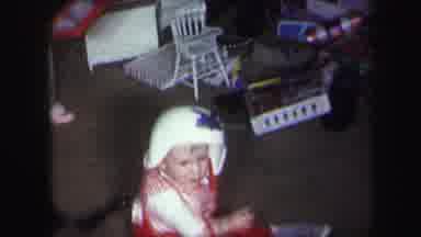 Lynbrook New York (1971): Baby Pulling Helmet Off Head While Toddler Plays With