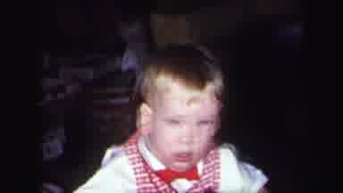 Lynbrook New York (1971): Infant In Red Outfit Looks Down Hits Something And Then