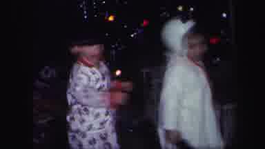 Lynbrook New York (1971): Two Small Children Wearing Pajamas And Hats Dancing In