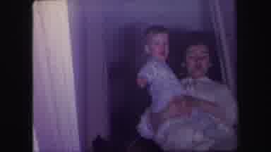 Lynbrook New York (1971): A Child Being Held By His Mother Is Pointing To