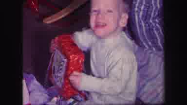 Lynbrook New York (1971): A Small Boys Is Sitting With A Gift Box Wrapped In A Red