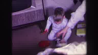 Lynbrook New York (1971): Mom Winding Up Toy Dog To Give To A Child