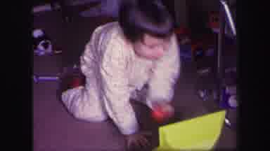 Lynbrook New York (1971): Child Playing With A Toy As Younger Brother Plays To The
