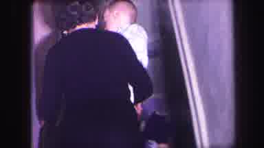 Lynbrook New York (1971): Mother Carrying A Child Up Stairs Another Child Waves At
