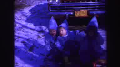 Lynbrook New York (1971): Three Boys In Winter Clothing Sit Together In Front Of A