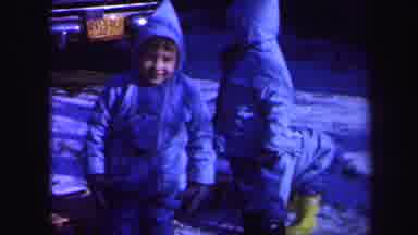 Lynbrook New York (1971): Three Kids Wearing Blue Coats Sit On Wooden Sled On A