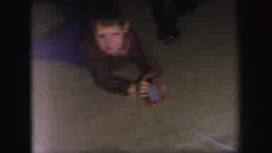 Lynbrook New York (1971): A Child Is Laying On His Stomach Playing With A