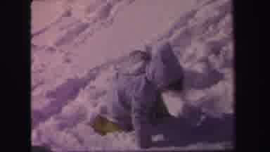 Lynbrook New York (1971): Child Wearing Blue Coat Plays In Snow On A Sunny Day