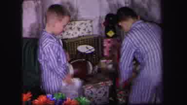 Lynbrook New York (1971): Three Children Opening Christmas Presents Around The