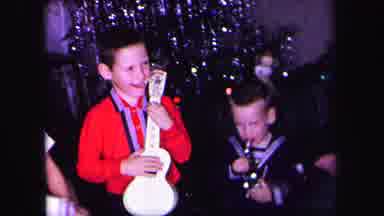 LYNBROOK NEW YORK-1971: Two Children Play Musical Instruments at Christmas