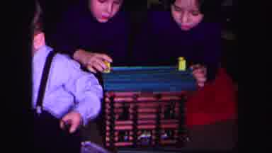Lynbrook New York (1971): Boy Wearing Blue Shirt Helps Other Kids Build Toy Log