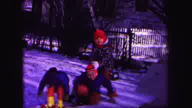 Lynbrook New York (1971): Children Wearing Red Pants Play In Snow On A Clear