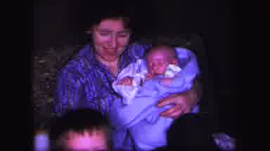 LYNBROOK NEW YORK-1971: Mother Puts Away Baby Bottle And Prepares Burp Rag For