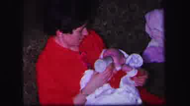 Lynbrook New York (1971): Mom In Red Outfit Bottle Feeding Infant On The Sofa