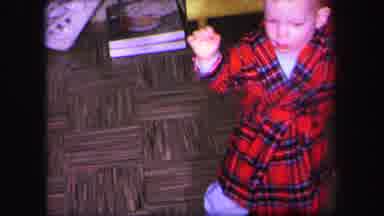 Lynbrook New York (1971): A Tiny Boy In A Red Robe Attempts To Walk With The Help