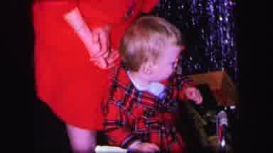 Lynbrook New York (1971): Young Boy With A Red Coat On Looks Around While Holding