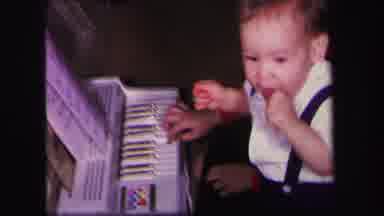 Lynbrook New York (1971): Young Boy In White Shirt And Suspenders Turns From Piano