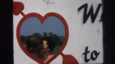 Lynbrook New York (1971): Couple Kissing Inside A Heart As Someone Takes Their
