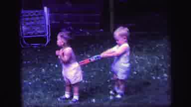 Lynbrook New York (1971): Two Toddlers Playing With Toys Outside During The Day