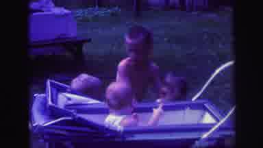 Lynbrook New York (1971): Big Brother Helping Younger Brothers Peer Into Baby