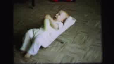 Lynbrook New York (1971): Baby Holding Bottle Rocking Back And Forth On Bouncer On