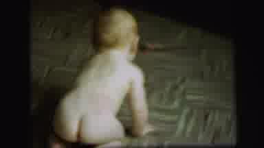 Lynbrook New York (1971): A Naked Baby Is Crawling On The Wooden Floor
