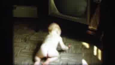 Lynbrook New York (1971): Nude Baby Crawling On Floor And Playing With Toy In
