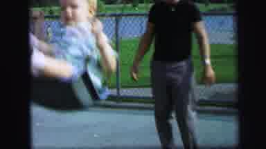 Lynbrook New York (1971): Well Dressed Man Pushes Two Toddlers On A Swing At The