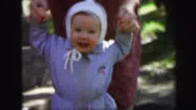Lynbrook New York (1971): Baby Walking On The Ground Holding Someone's Hands Being