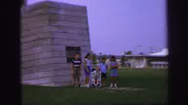 Lynbrook New York (1971): A Group Of Kids Standing And Posing In Front Of Some