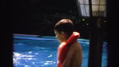 Lynbrook New York (1971): A Child Is Sitting In The Swimming Pool And Wearing A