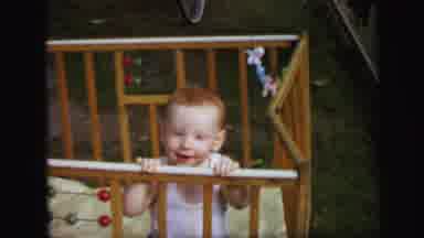 Lynbrook New York (1971): Baby In A Play Crib While Another Boy Drinks A Bottle On