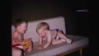 Lynbrook New York (1971): Two Babies Are Playing And Laughing In The Sofa