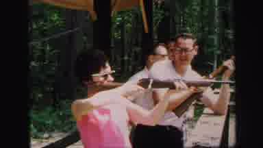 Lynbrook New York (1971): Woman Taking Aim With Rifle And Target Shooting As Men