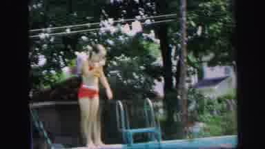 Lynbrook New York (1971): A Boy And A Girl Jumping Off The Edge Of The Pool Into