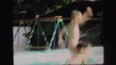 Lynbrook New York (1971): Two Young Boys Play In The Pool Together And Jump In The