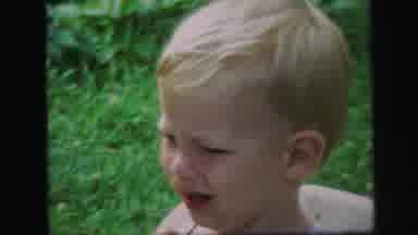Lynbrook New York (1971): Young Child Bouncing In Baby Chair In A Garden Another