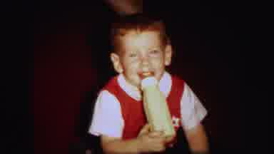 Lynbrook New York (1971): Baby In Red Vest Takes A Large Sip From His Giant Bottle