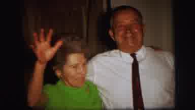 Lynbrook New York (1971): Man In White Stands With Lady In Green As She Waves To